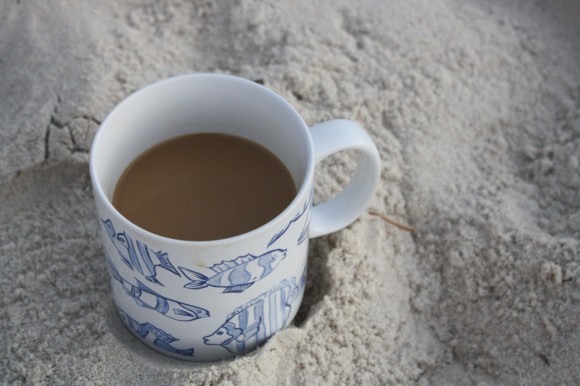 Coffee mug on beach